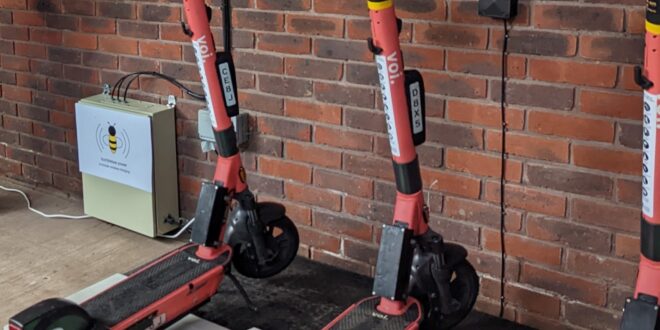 E scooters recharging on wireless charging pads Voi launches first wireless e-scooter charging trial in UK